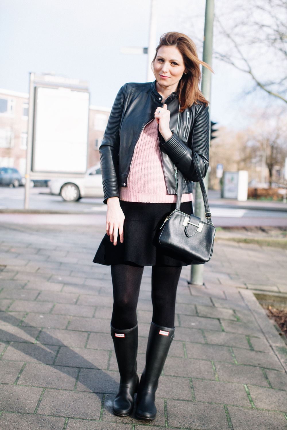 Black and Pink Outfit for Fall featured by top US fashion blog, Tea Cups & Tulips: image of a woman wearing Black leather jacket and light pink sweater