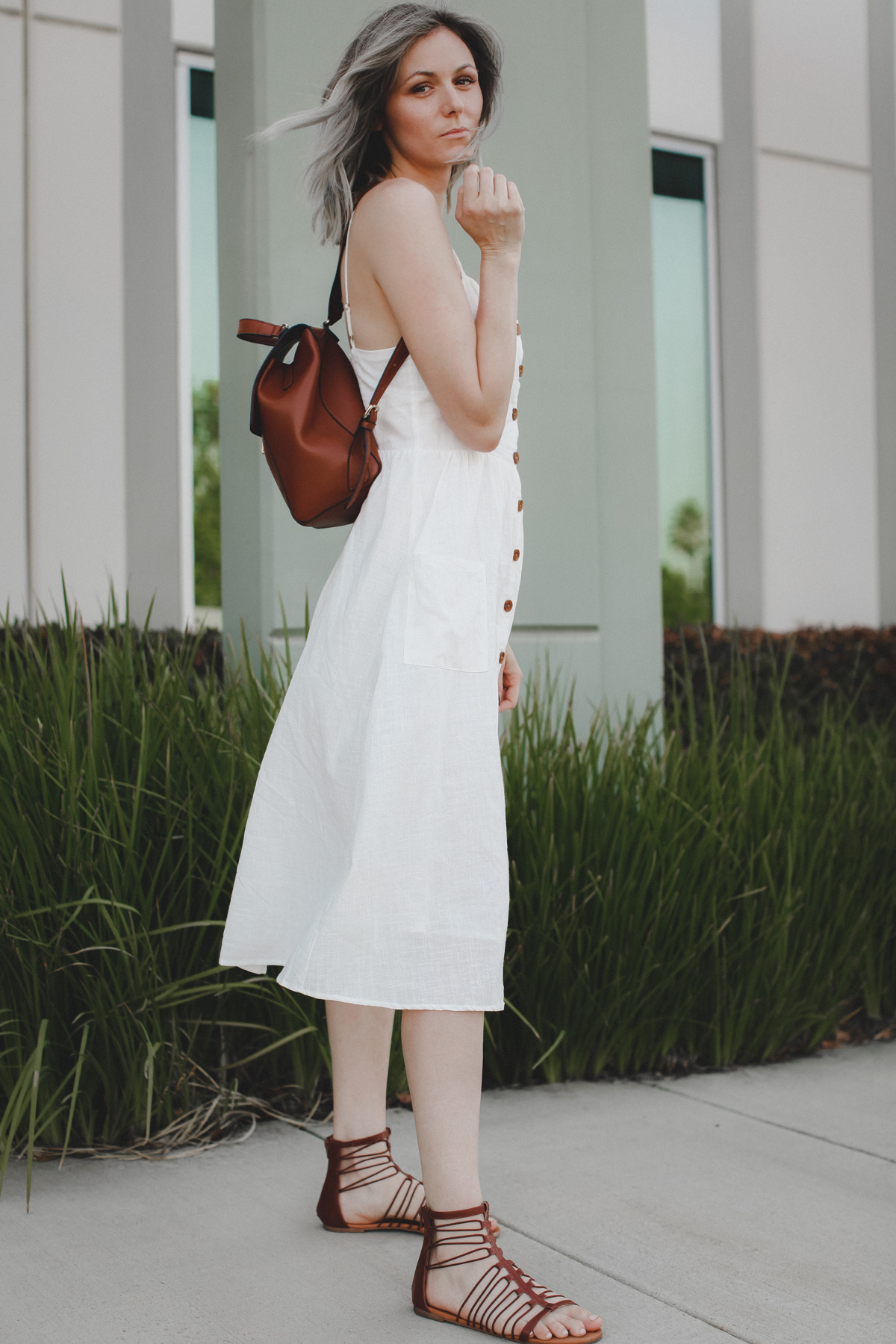 Casual outfit featuring a white midi dress and brown accessories
