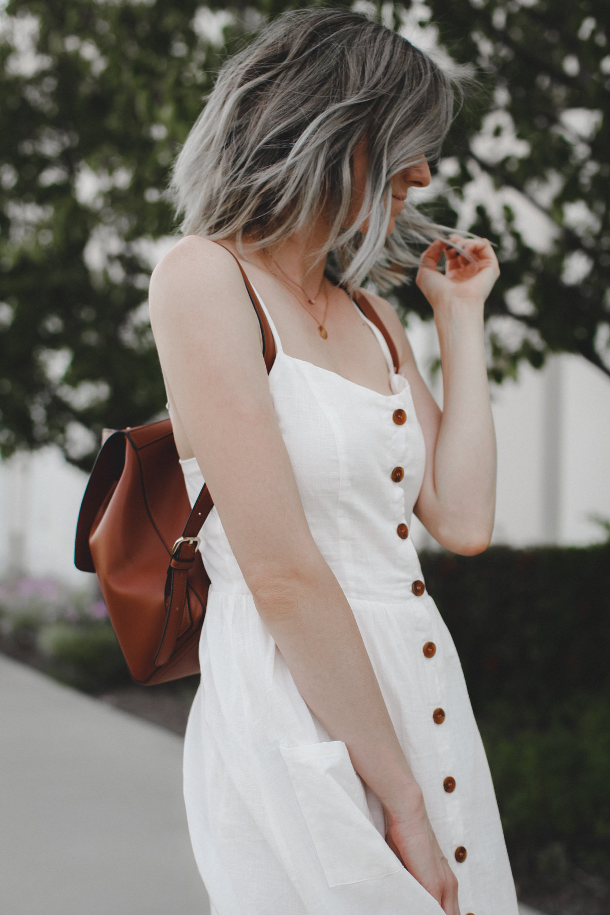 Short grey hair and white dress