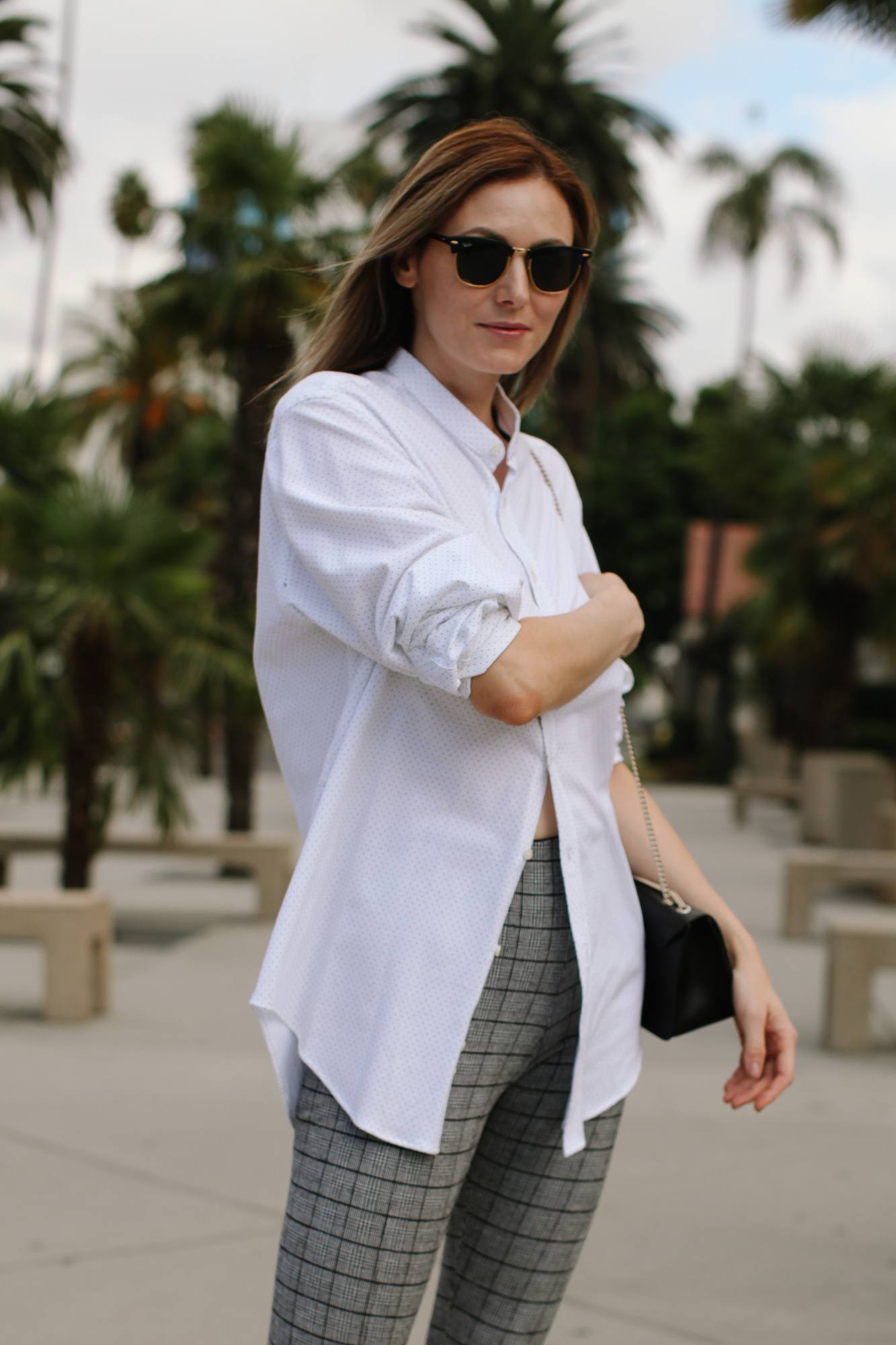 how to style an oversized button down shirt | How to Style An Oversized Button Down Shirt by popular Southern California fashion blog, Tea Cups and Tulips: image of a woman outside wearing a Zara oversized button down shirt, Banana Republic Petite Modern Sloan Skinny-Fit Washable Pant with Piping, Ray-Ban sunglasses, Happiness Boutique Circle Pendant Necklace Rose Gold, and FURLA Bella Saffiano Mini Crossbody.