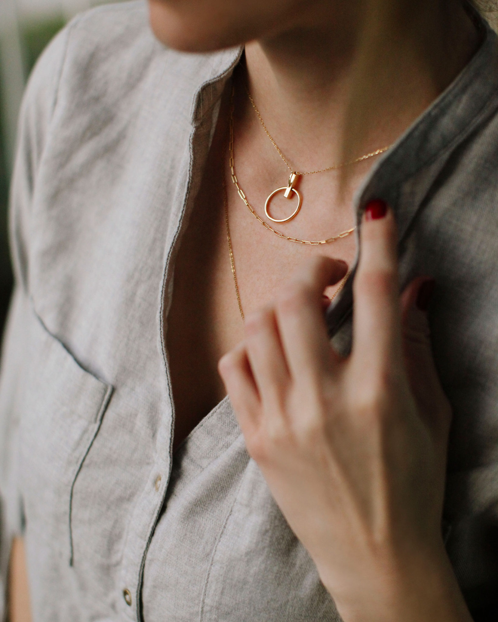 Dainty gold necklaces. How to layer necklaces. | Dainty Gold Necklaces and How to Layer Them by popular fashion blog, Tea Cups and Tulips: image of a woman wearing layered dainty gold necklaces.