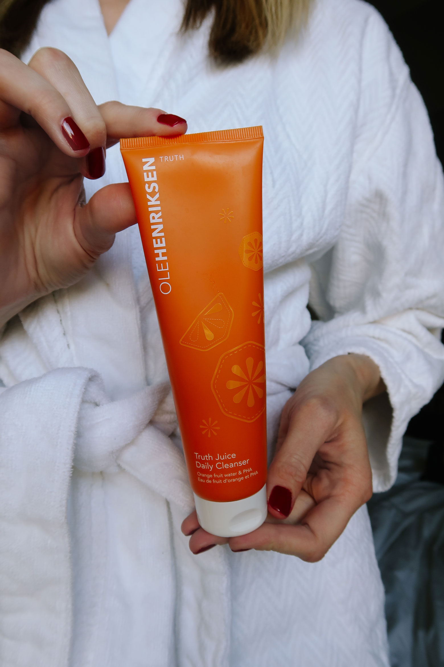 Ole Henriksen Truth Juice Daily Cleanser Review by popular LA beauty blog, Tea Cups and Tulips: image of a woman holding ole henriksen truth juice daily cleanser.